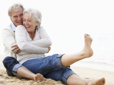 Senior couple sitting at a beach